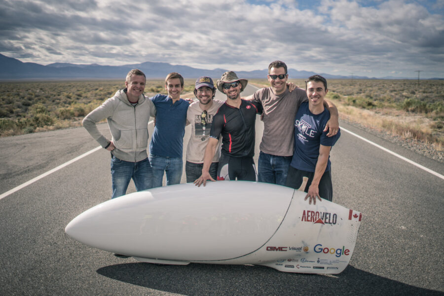 UTIAS Alums Todd Reichert and Cameron Robertson pose with the sleek Aero high-speed bike and their world class team