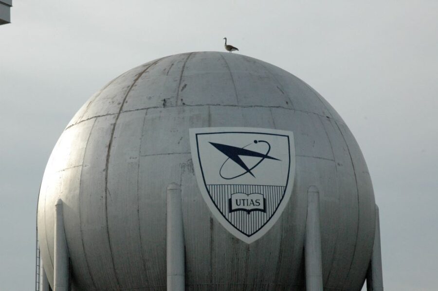 The reassembled giant metal Sphere (a vacuum sphere for supersonic tests) gleaming in the sun, a Canada goose sitting at its summit.