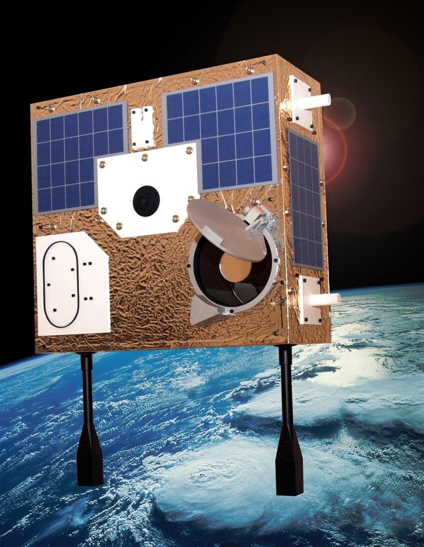 Model of MOST satellite illustrated in orbit above the earth.