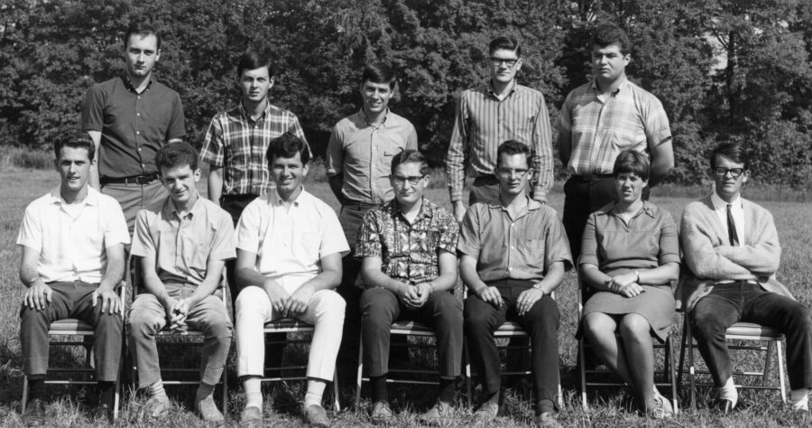 A dozen graduate students pose for a photo outside in 1974. Adele Buckley, seated second from the right, is the only woman present.