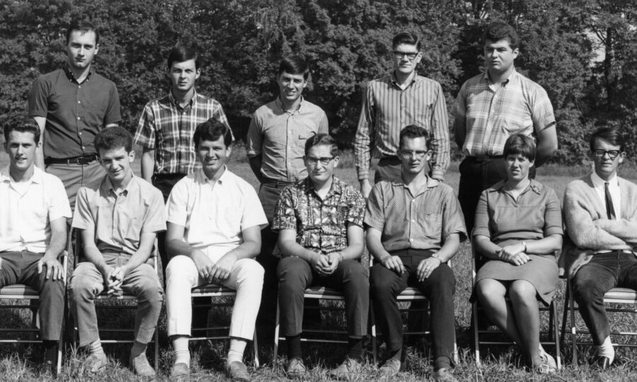 A dozen graduate students pose for a photo outside in 1974. Adele Buckley, seated second from the right, is the only woman present.